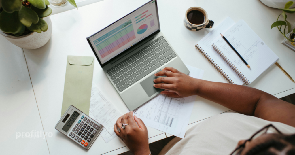 College student budgeting with laptop and notebook