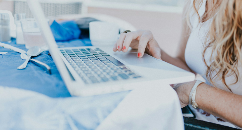 Nurse writing health content on a laptop at a desk