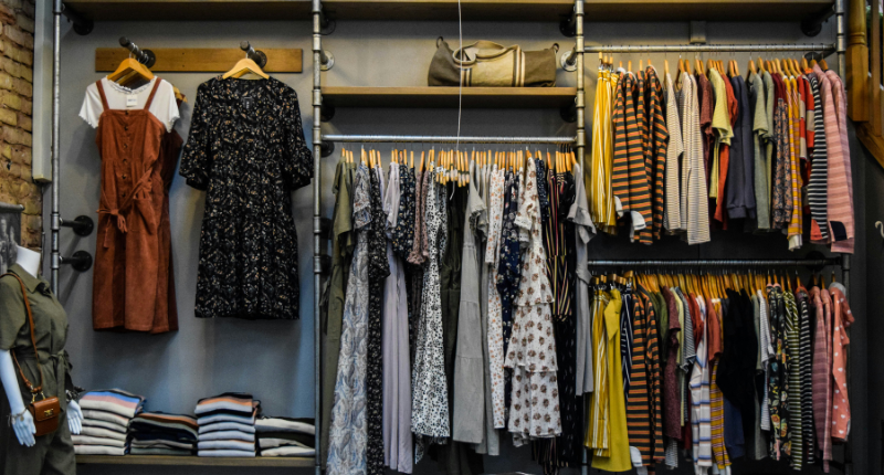Woman sorting thrifted clothing items to resell online