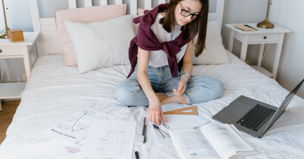 Student working on laptop as one of many side hustles for college students