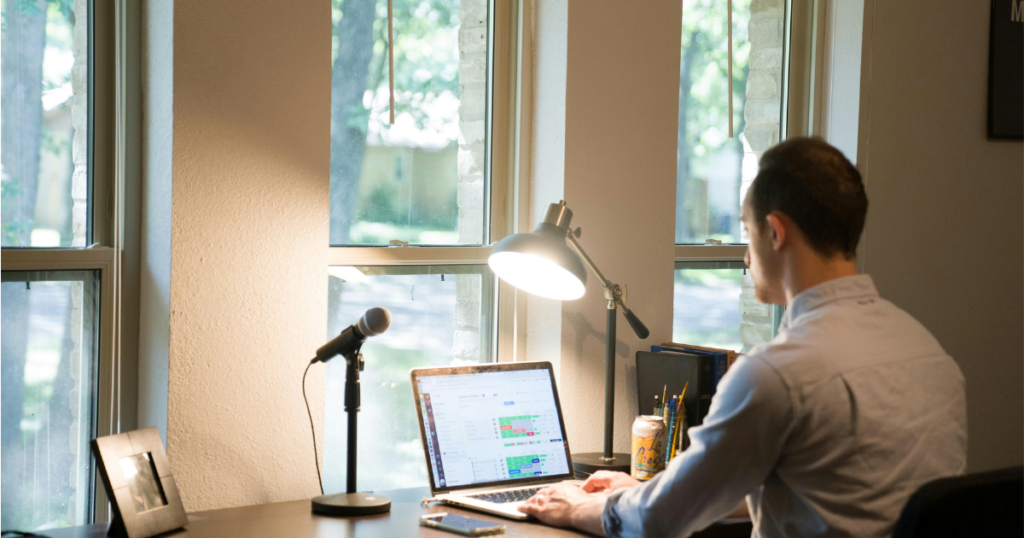 Teacher working on a laptop, exploring side hustles for teachers