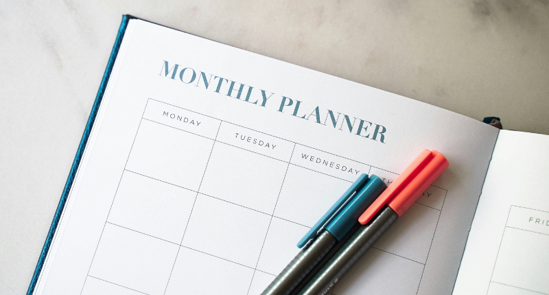 Person planning a side hustle schedule in a notebook