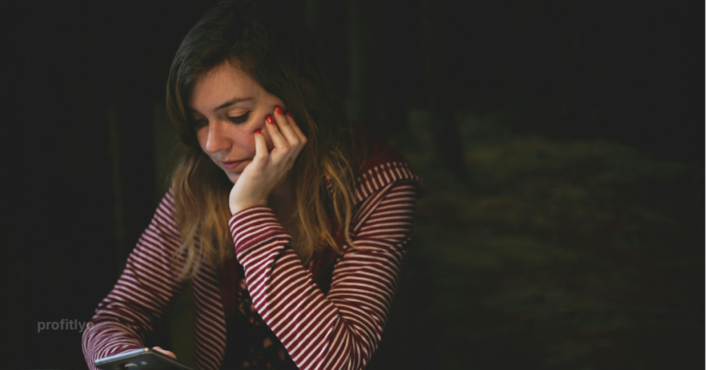 Person stressed about how to stop living paycheck to paycheck while checking bank balance