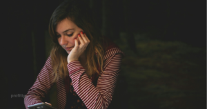 Person stressed about how to stop living paycheck to paycheck while checking bank balance