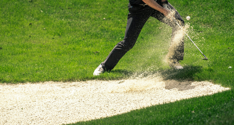 Groundskeeper mowing a golf course, a relaxing summer side job for teachers